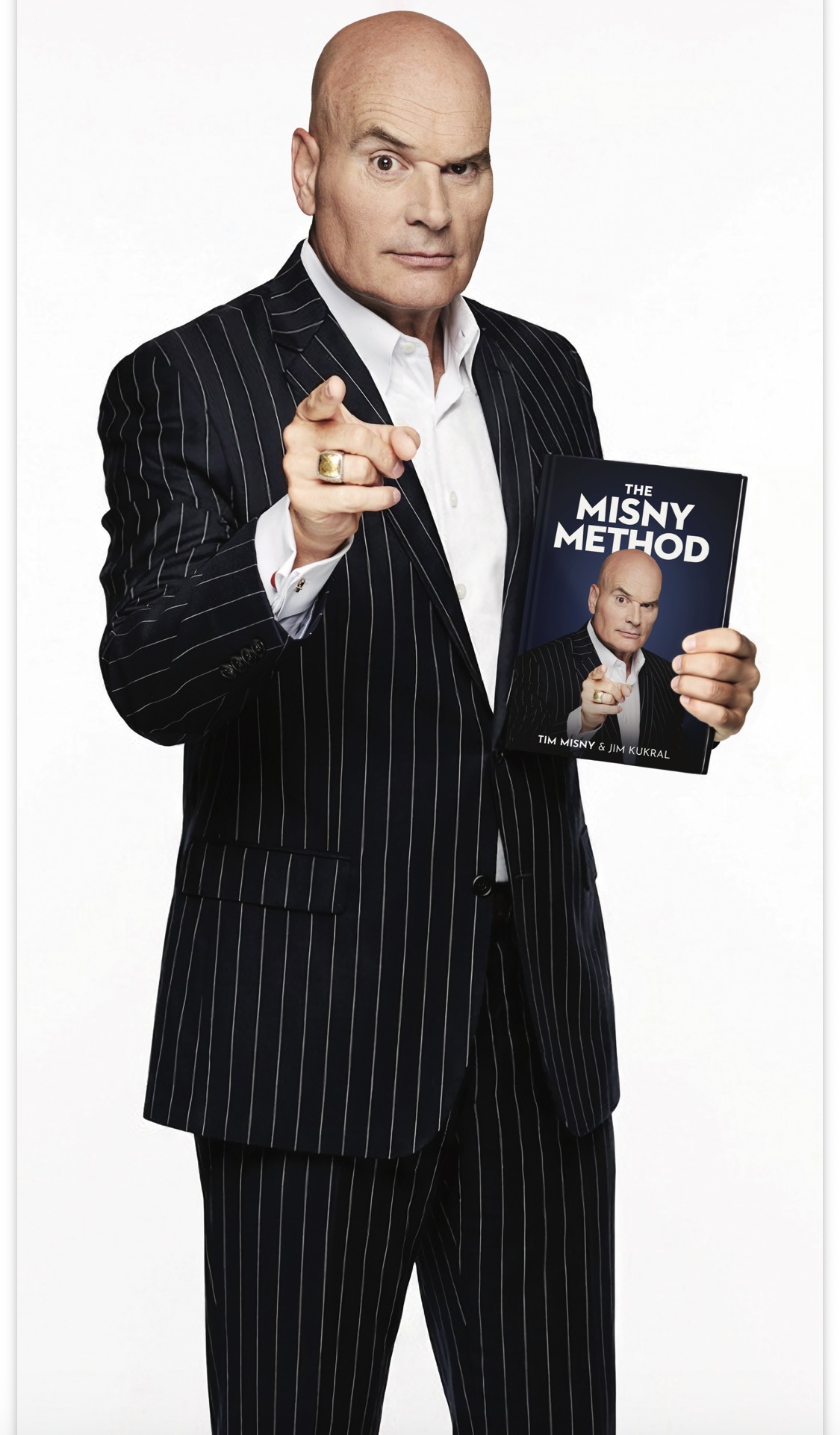 Tim Misny holding a copy of The Misny Method